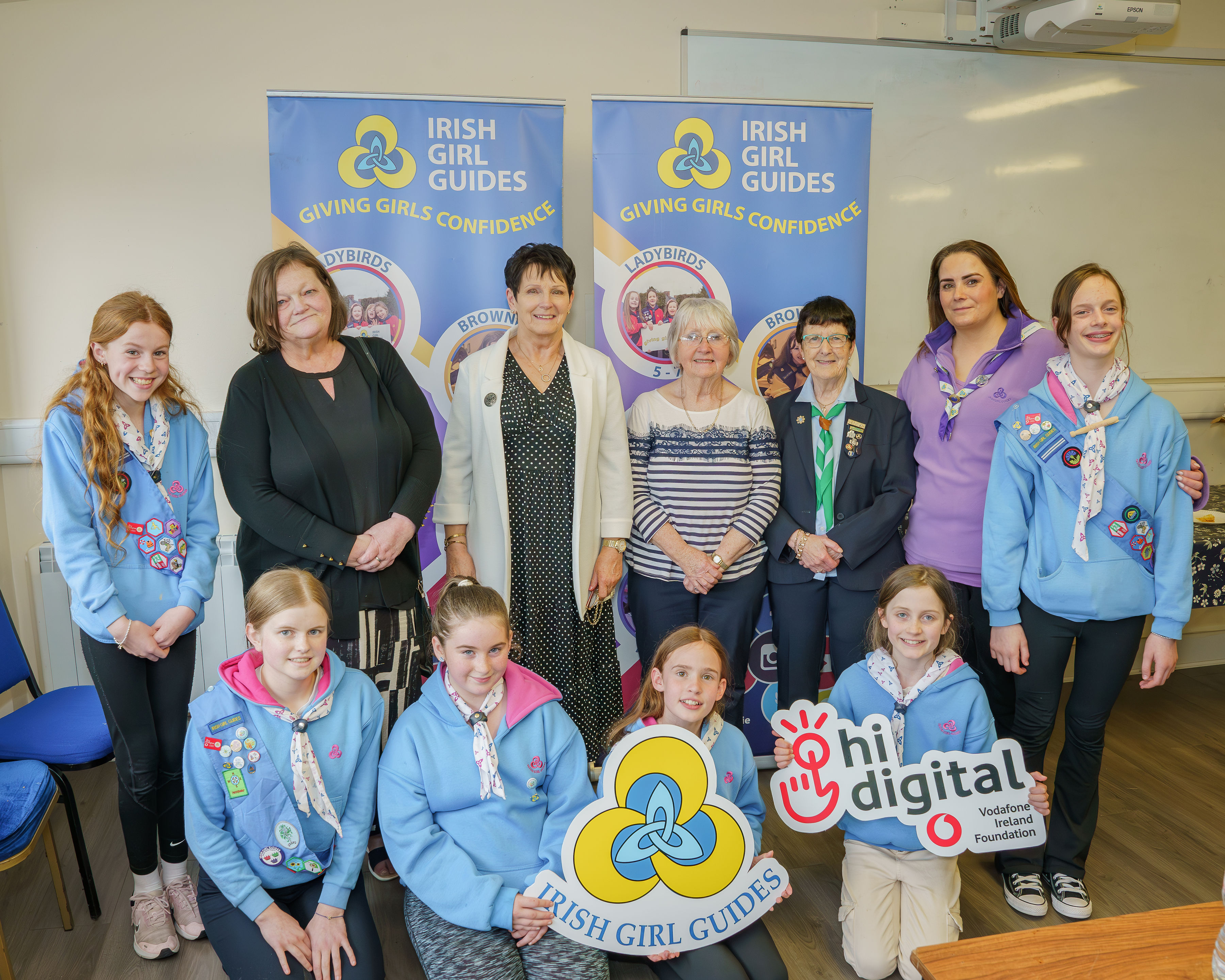 image of Irish Girl Guides group pictured with Forest Hall Michels Town representatives, mix of girls and women of all ages
